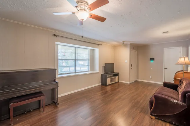 a view of livingroom with furniture wooden floor and windows