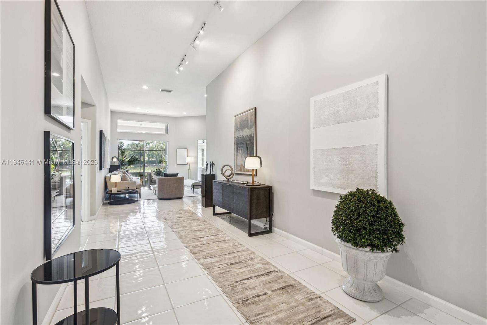 2883 Oakbrook Drive Weston, FL 33332 - Photo 14 of 74 a living room with furniture and a chandelier
