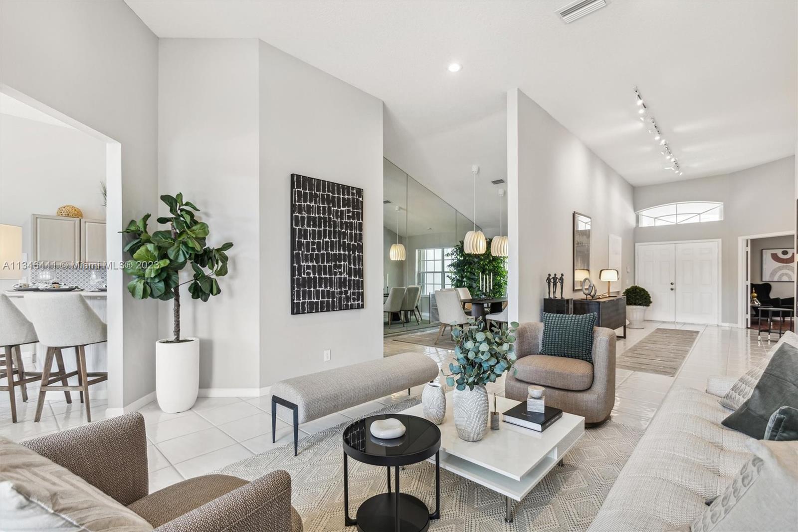 2883 Oakbrook Drive Weston, FL 33332 - Photo 18 of 74 a living room with furniture a rug and a potted plant