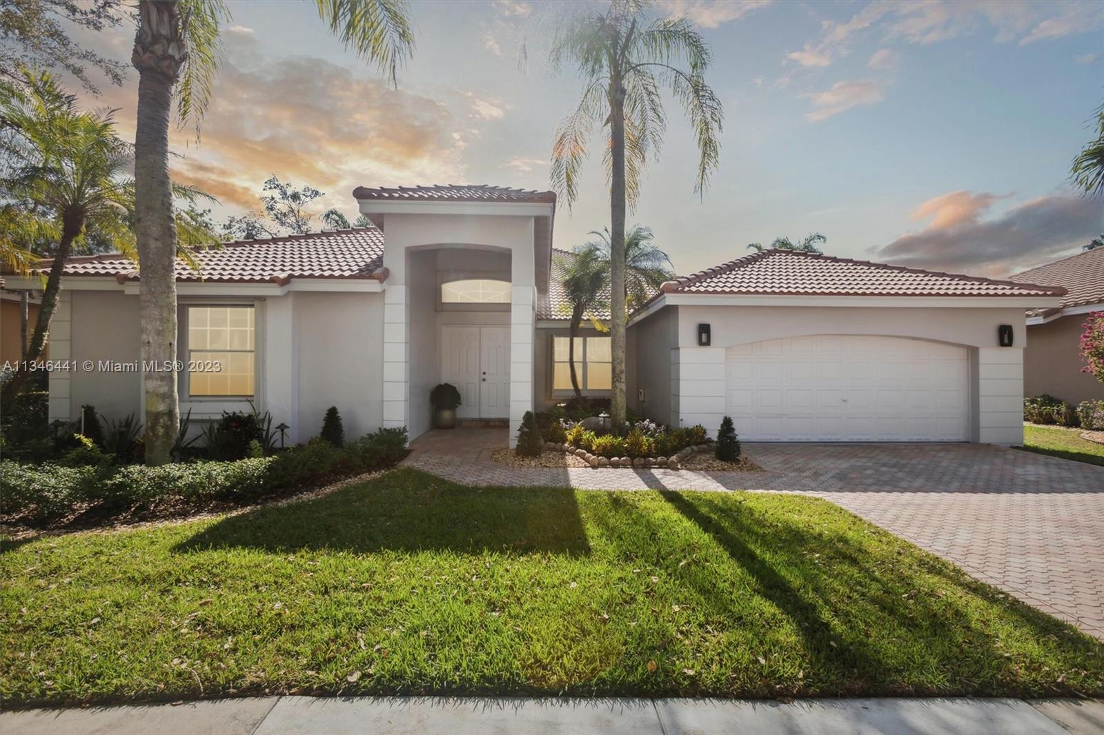 2883 Oakbrook Drive Weston, FL 33332 - Photo 2 of 74 front view of house with a yard
