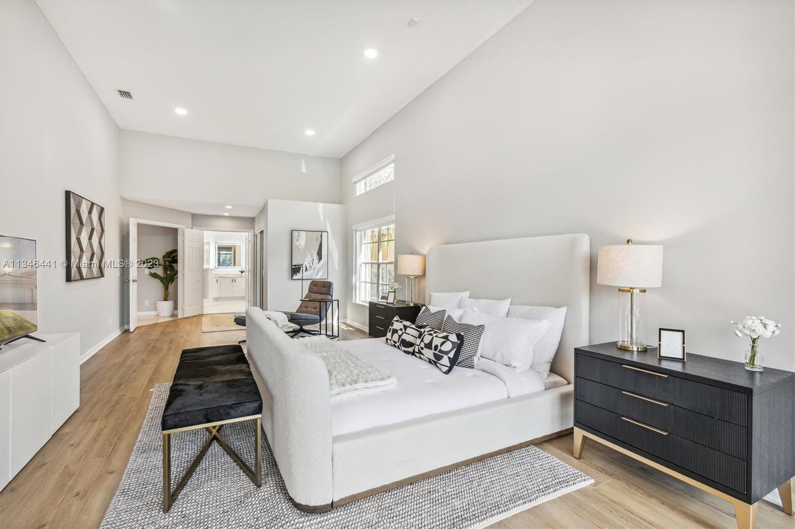2883 Oakbrook Drive Weston, FL 33332 - Photo 27 of 74 a living room with furniture a rug and a lamp