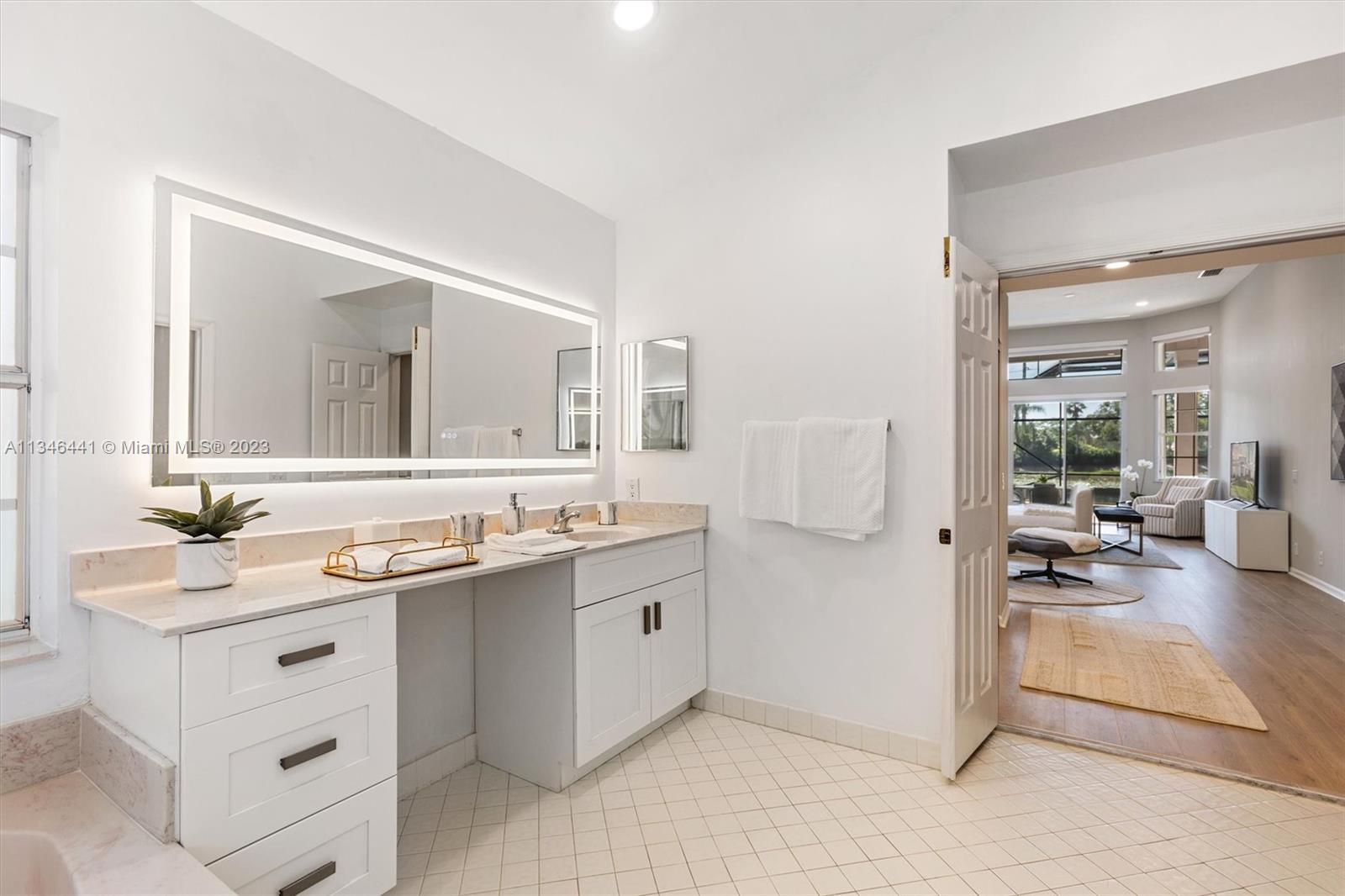 2883 Oakbrook Drive Weston, FL 33332 - Photo 30 of 74 a spacious bathroom with a double vanity sink and a mirror