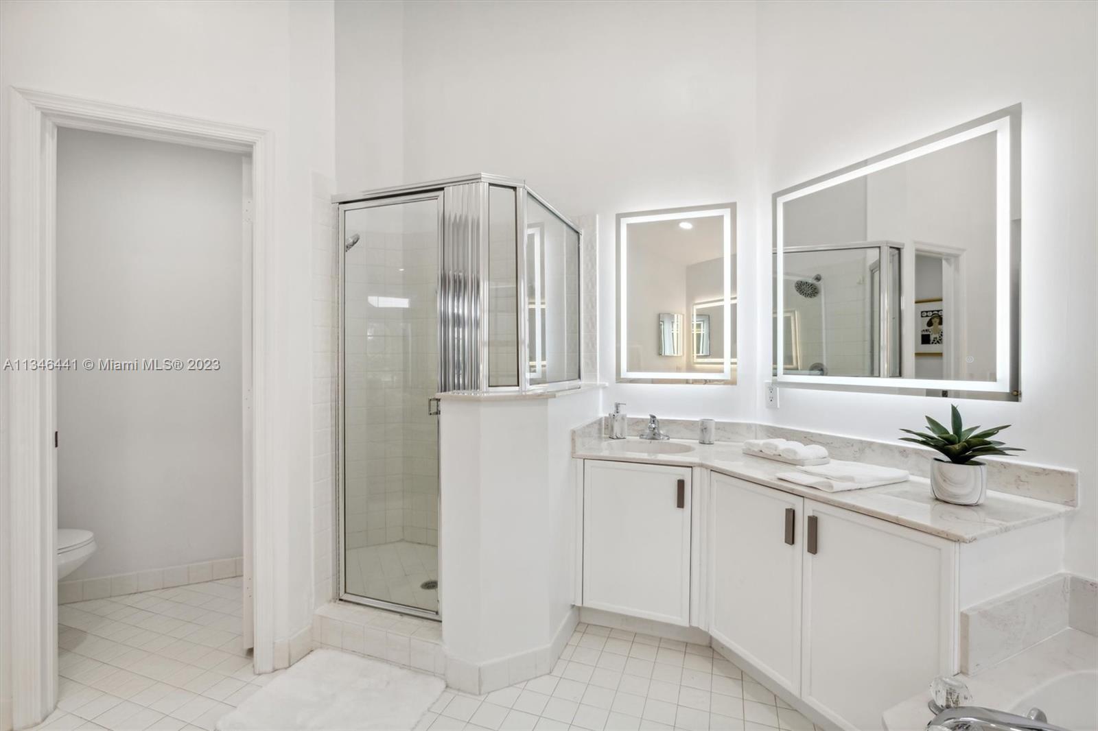 2883 Oakbrook Drive Weston, FL 33332 - Photo 32 of 74 a bathroom with a granite countertop sink and a mirror