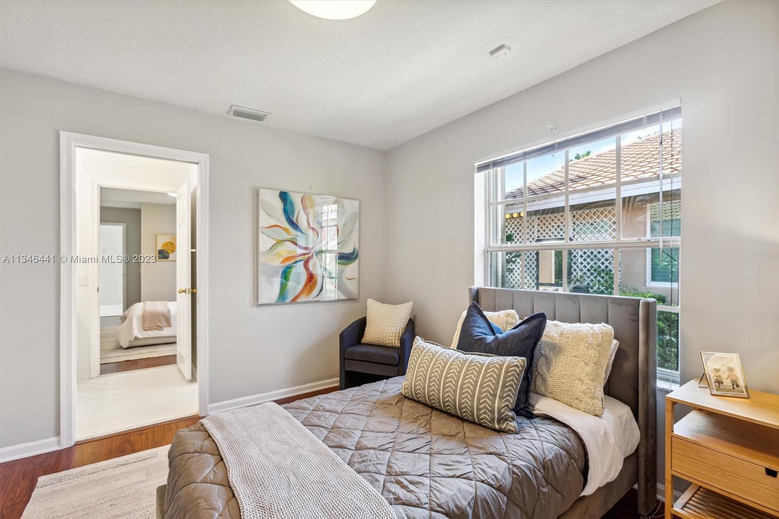 2883 Oakbrook Drive Weston, FL 33332 - Photo 33 of 74 a bedroom with a large bed and a window