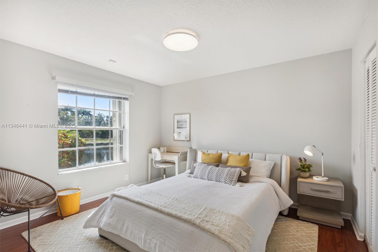 2883 Oakbrook Drive Weston, FL 33332 - Photo 40 of 74 a bedroom with a bed and wooden floor