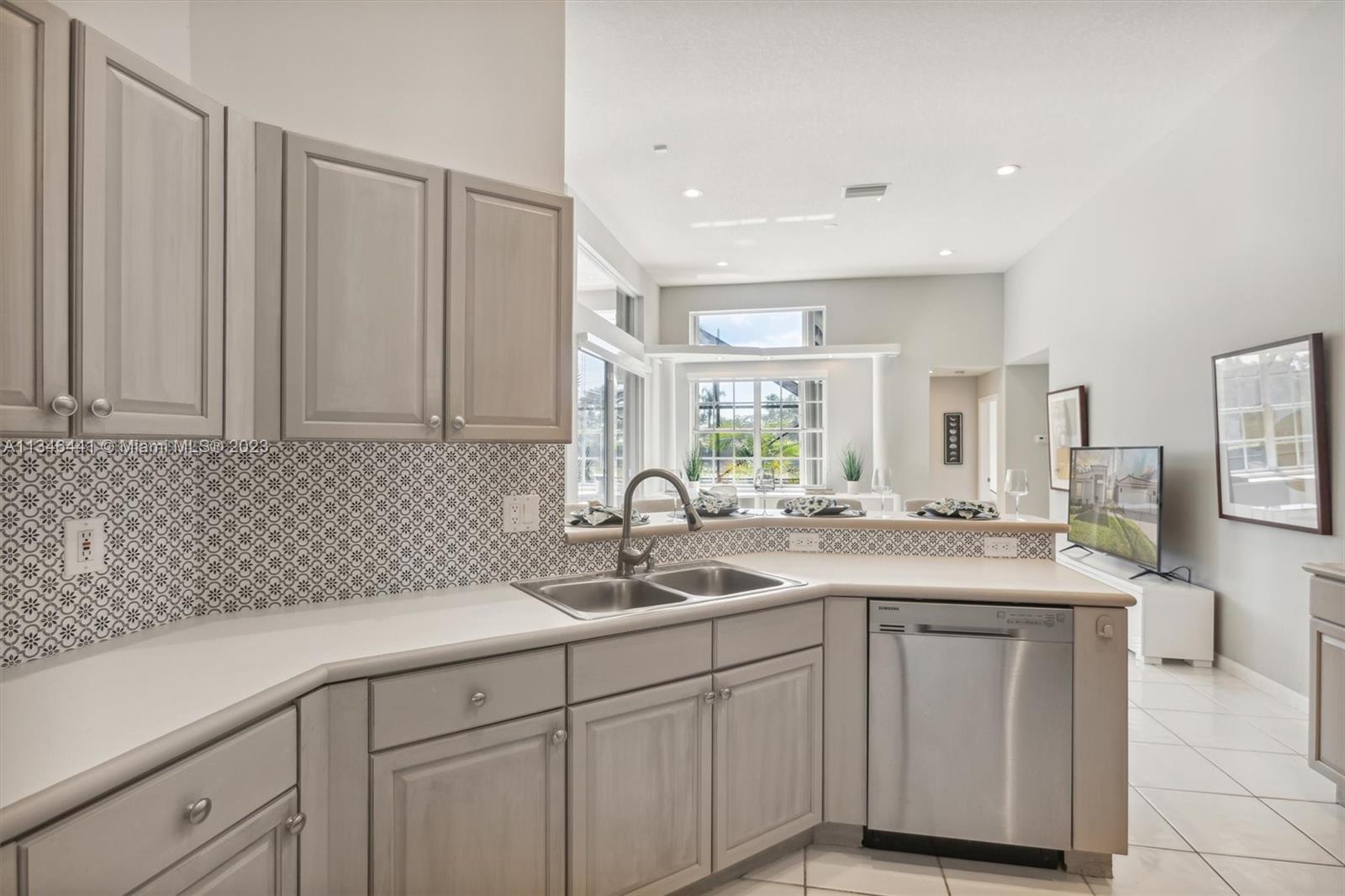 2883 Oakbrook Drive Weston, FL 33332 - Photo 47 of 74 a kitchen with a sink and cabinets