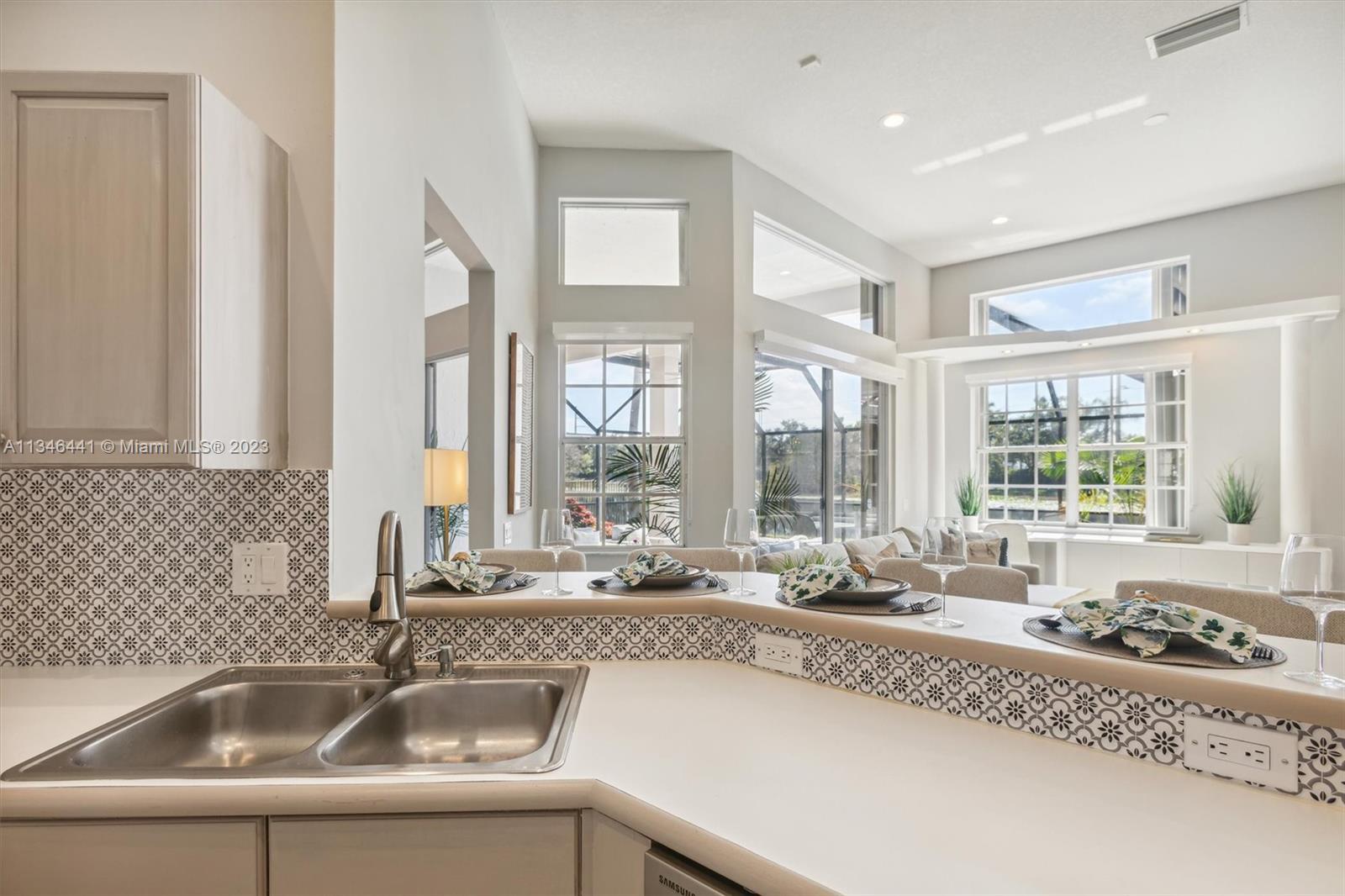 2883 Oakbrook Drive Weston, FL 33332 - Photo 48 of 74 a bathroom with a granite countertop sink and large window