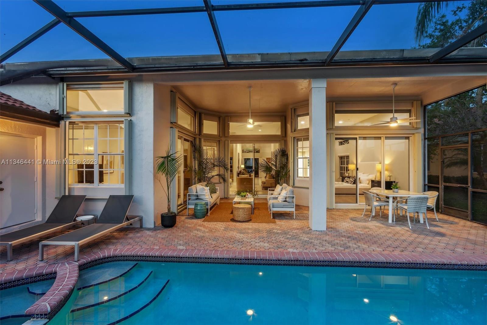 2883 Oakbrook Drive Weston, FL 33332 - Photo 49 of 74 a view of a patio with table and chairs a barbeque grill and wooden floor