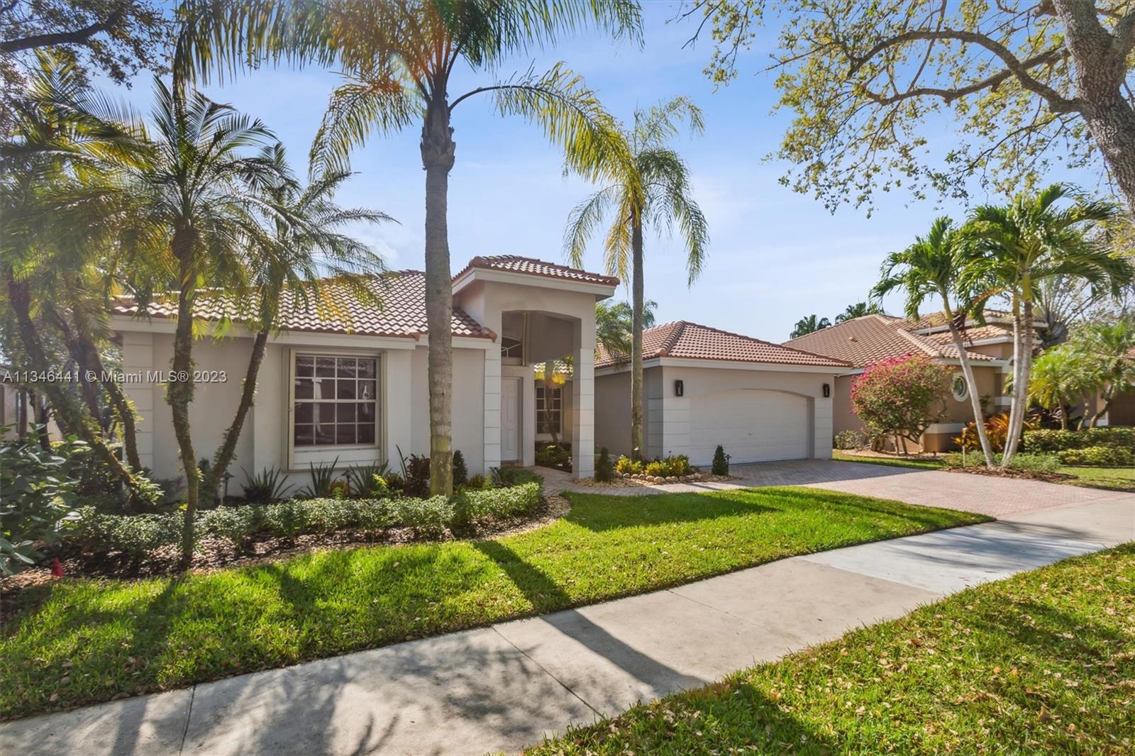 2883 Oakbrook Drive Weston, FL 33332 - Photo 5 of 74 a front view of house with yard and green space