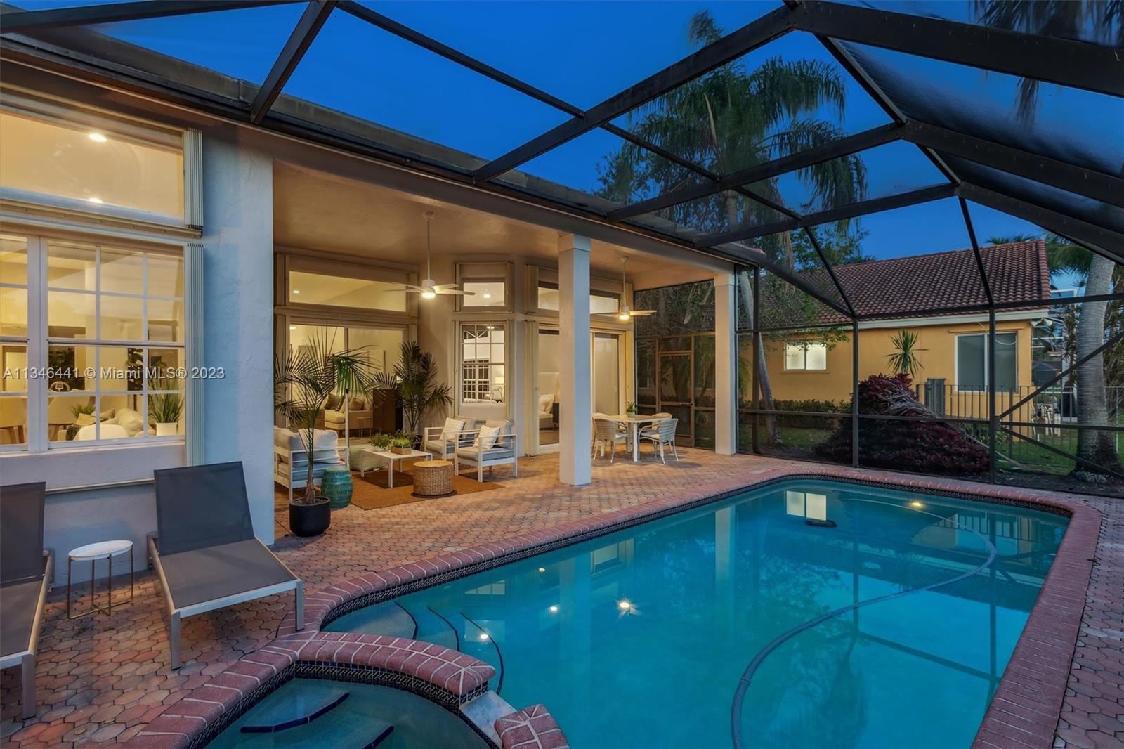 2883 Oakbrook Drive Weston, FL 33332 - Photo 51 of 74 a outdoor space with chairs and umbrella