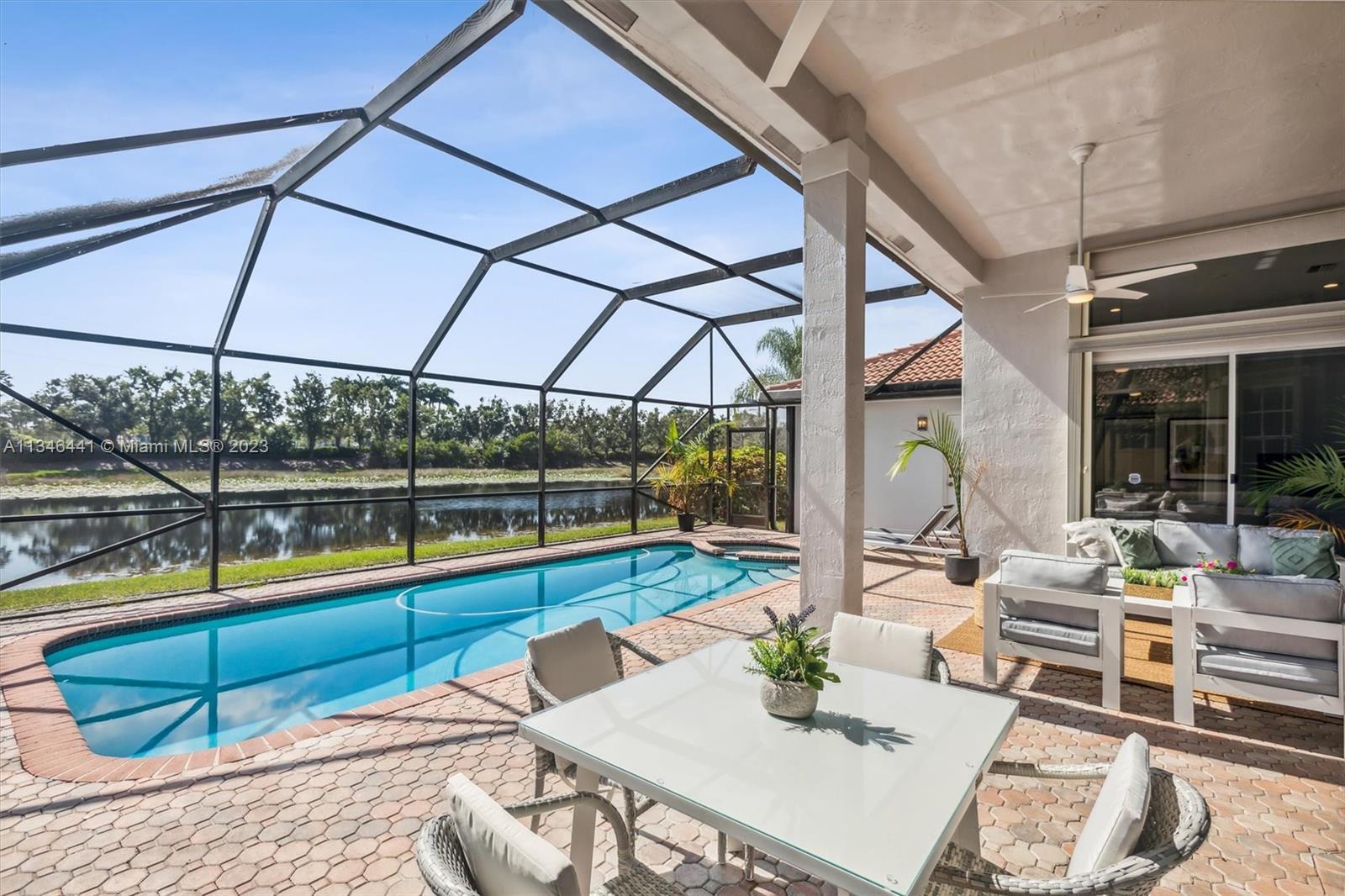 2883 Oakbrook Drive Weston, FL 33332 - Photo 53 of 74 a view of a patio with a table and chairs under an umbrella
