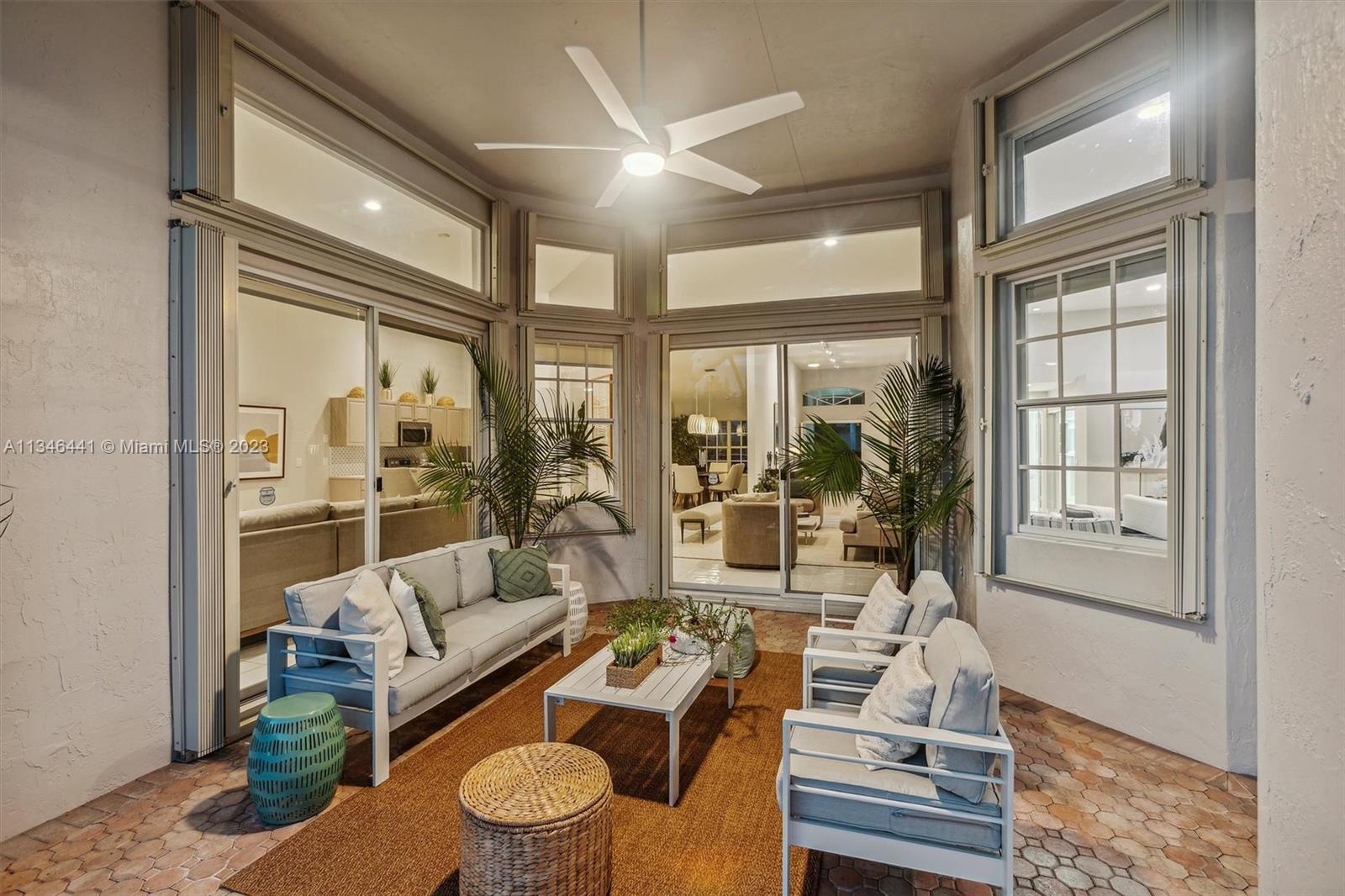 2883 Oakbrook Drive Weston, FL 33332 - Photo 58 of 74 a living room with furniture and a floor to ceiling window