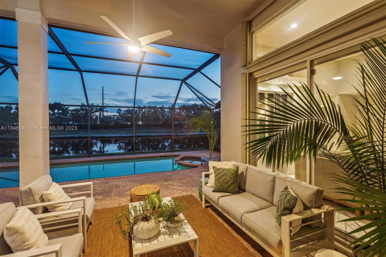 2883 Oakbrook Drive Weston, FL 33332 - Photo 60 of 74 a outdoor living space with furniture and umbrella