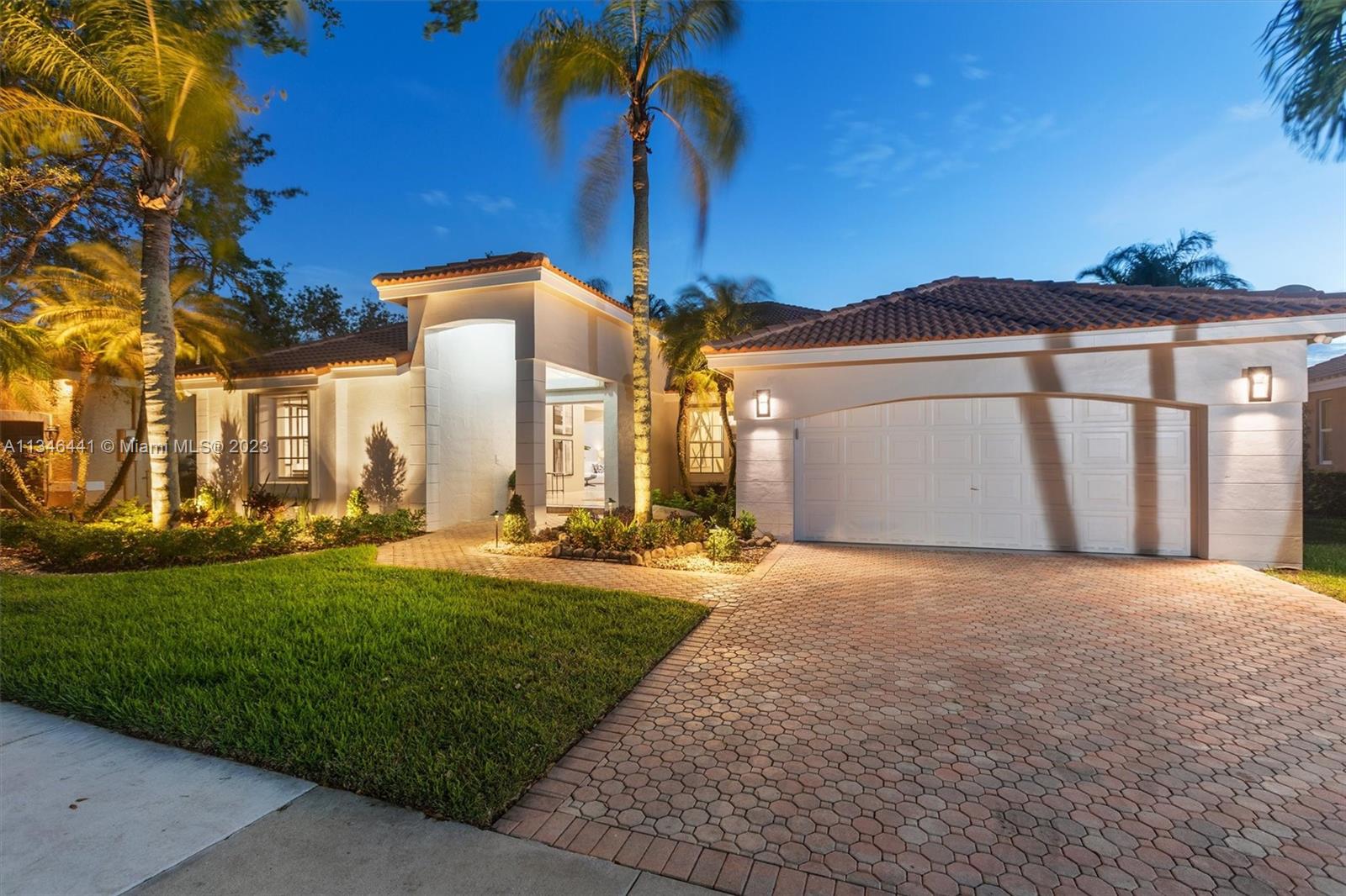 2883 Oakbrook Drive Weston, FL 33332 - Photo 9 of 74 a front view of a house with a yard