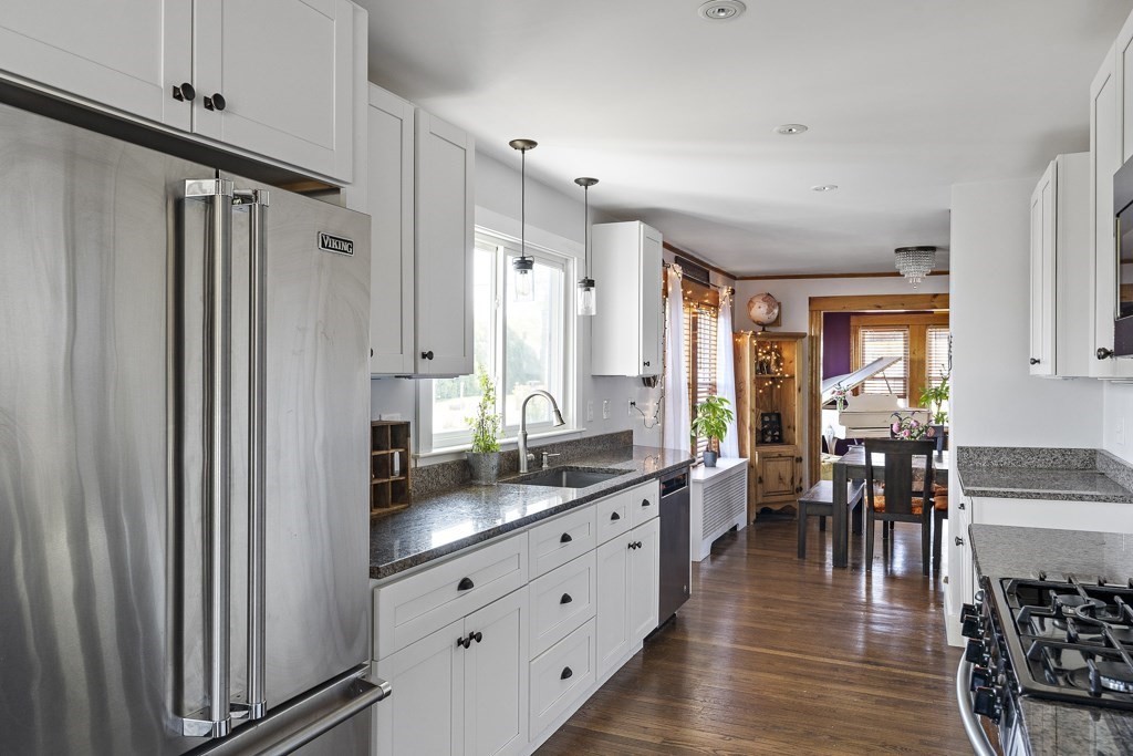 98 Summit Street Weymouth, MA 02188 - Photo 11 of 31 a large white kitchen with stainless steel appliances a lot of counter space and a window