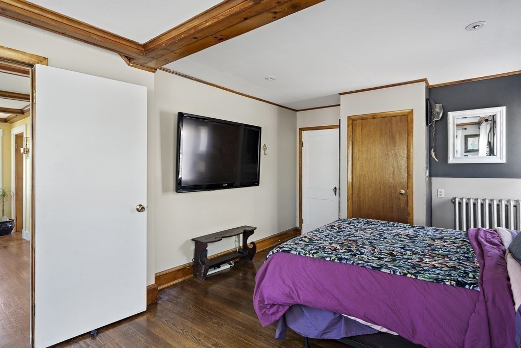 98 Summit Street Weymouth, MA 02188 - Photo 14 of 31 a bedroom with a bed and a flat screen tv