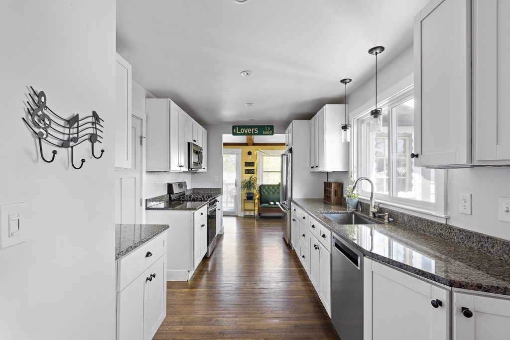 98 Summit Street Weymouth, MA 02188 - Photo 9 of 31 a large kitchen with stainless steel appliances lots of counter space and wooden floor