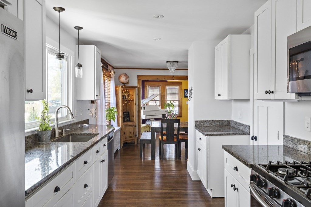 98 Summit Street Weymouth, MA 02188 - Photo 10 of 31 a kitchen with stainless steel appliances granite countertop a stove a sink and a refrigerator