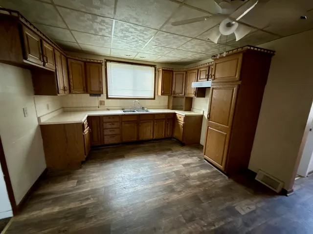 a kitchen with refrigerator and sink