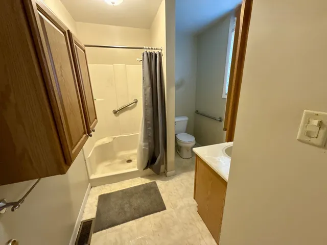 a bathroom with a tub a sink and a mirror