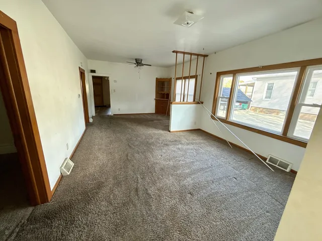 a view of livingroom with hardwood floor and front door