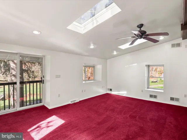 an empty room with a empty space and windows