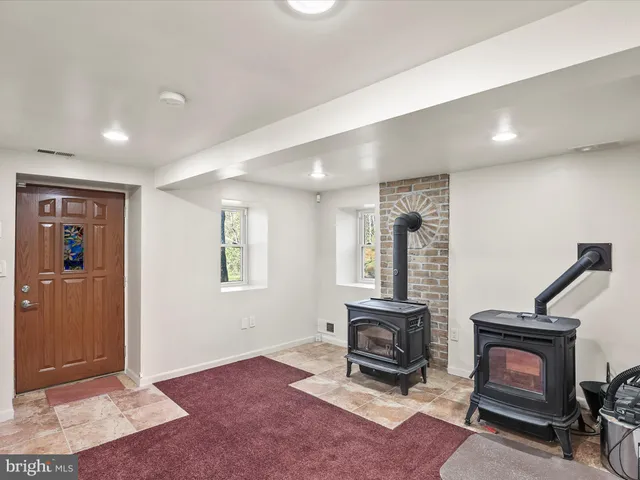 a front view of house with yard and trees in the background