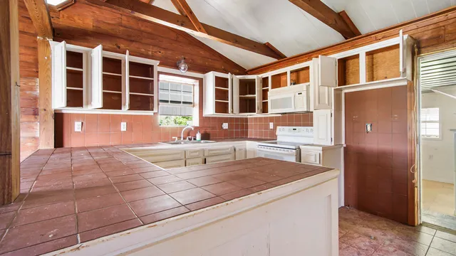 a kitchen with stainless steel appliances granite countertop a sink and cabinets