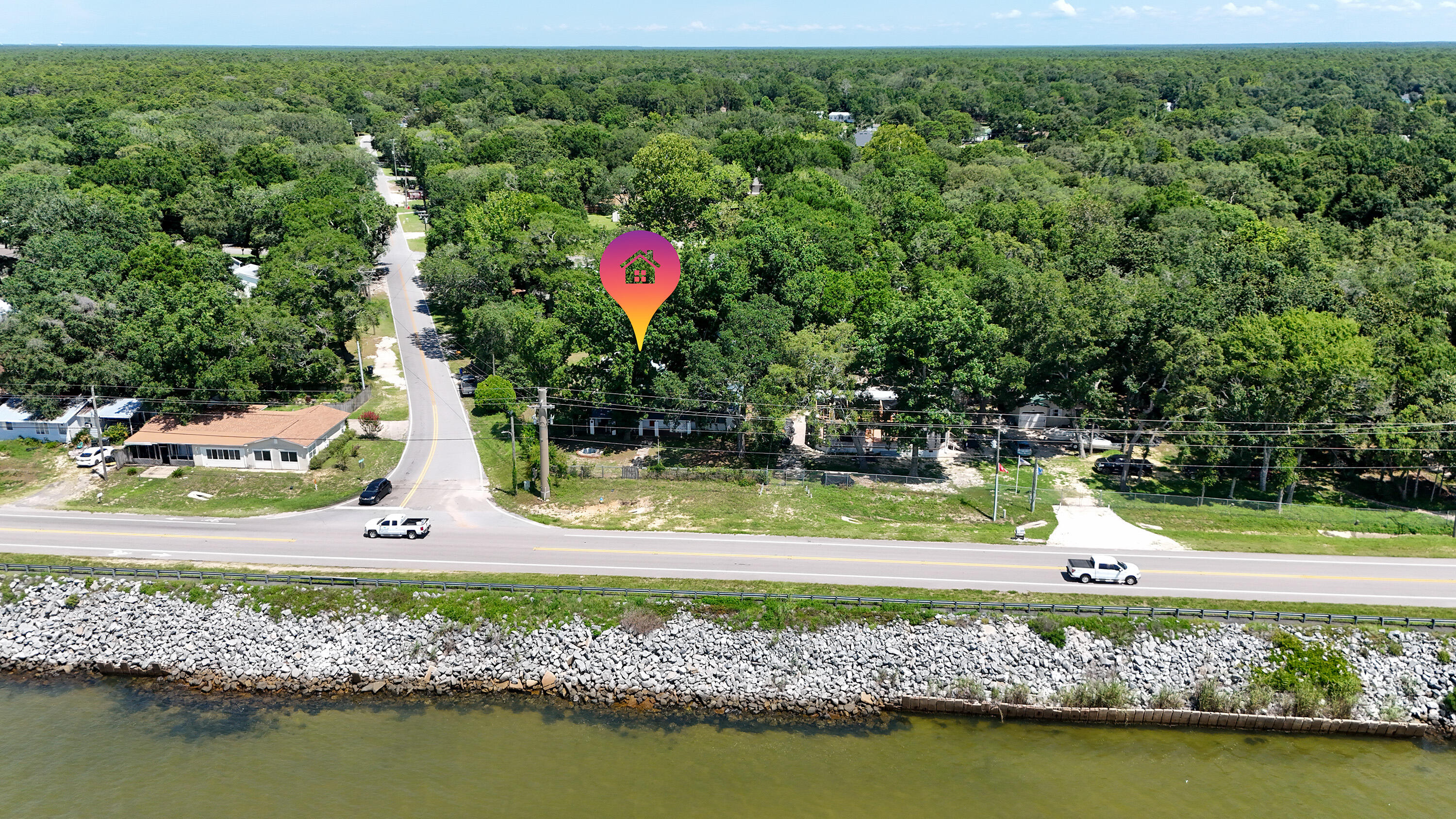 13636 Highway 20 Freeport, FL 32439 - Photo 36 of 42 a view of a wooden house with a yard and potted plants