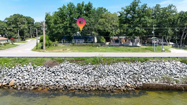 an aerial view of a house with a yard and garden