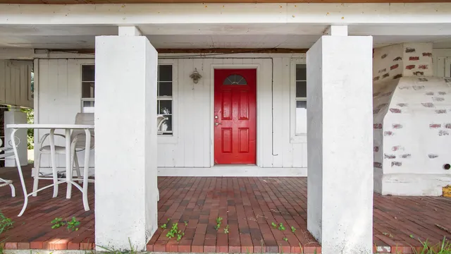 a view of a large white house with a yard