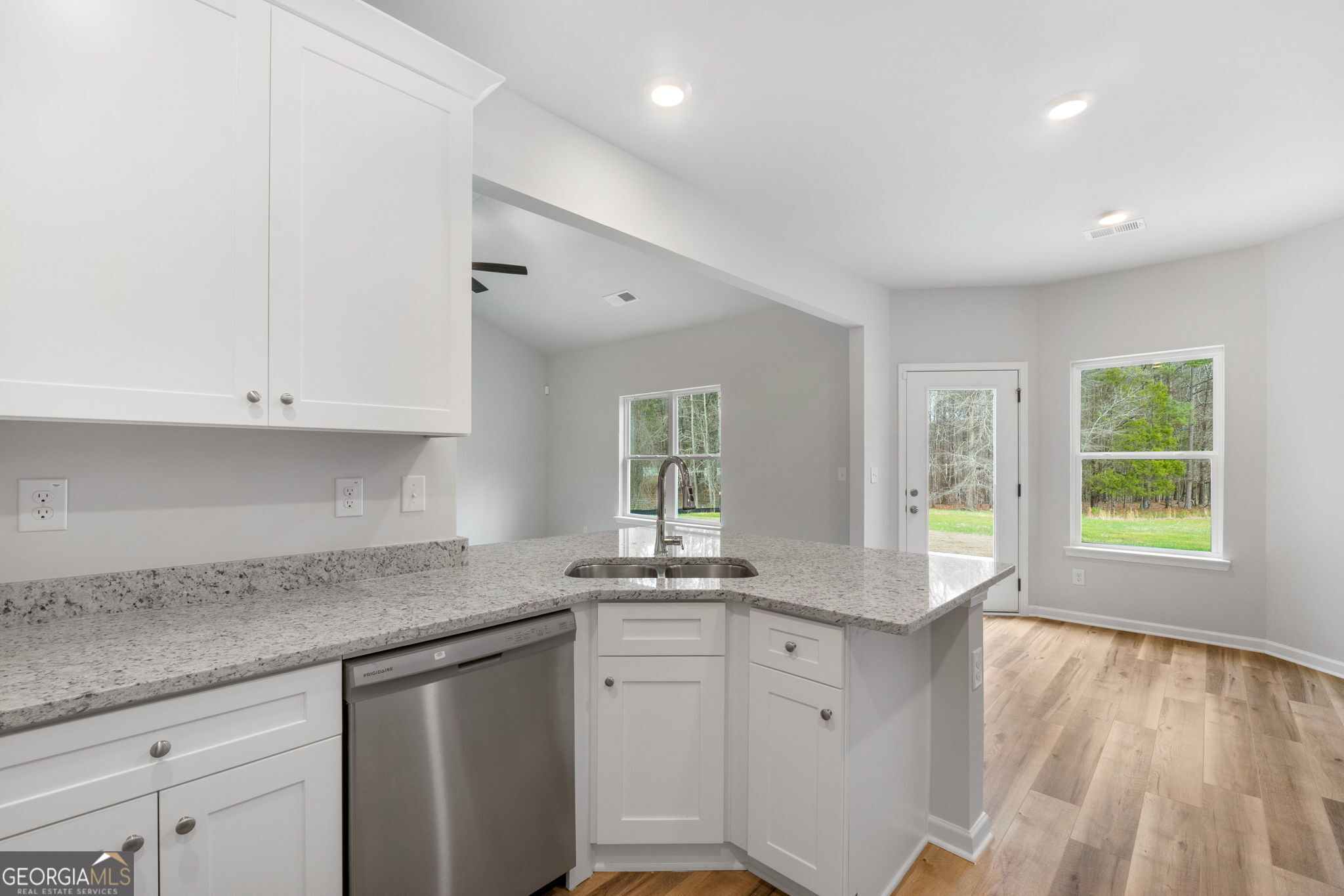 156 Charlie Fuller Road Grantville, GA 30220 - Photo 13 of 36 a kitchen with granite countertop white cabinets and a window