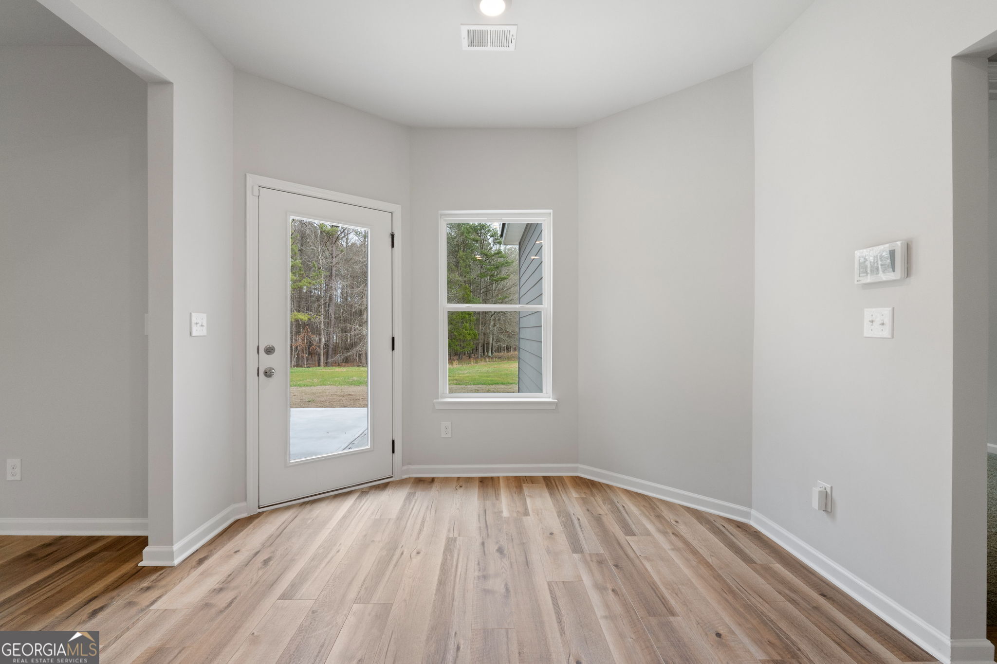 156 Charlie Fuller Road Grantville, GA 30220 - Photo 15 of 36 an empty room with wooden floor and windows