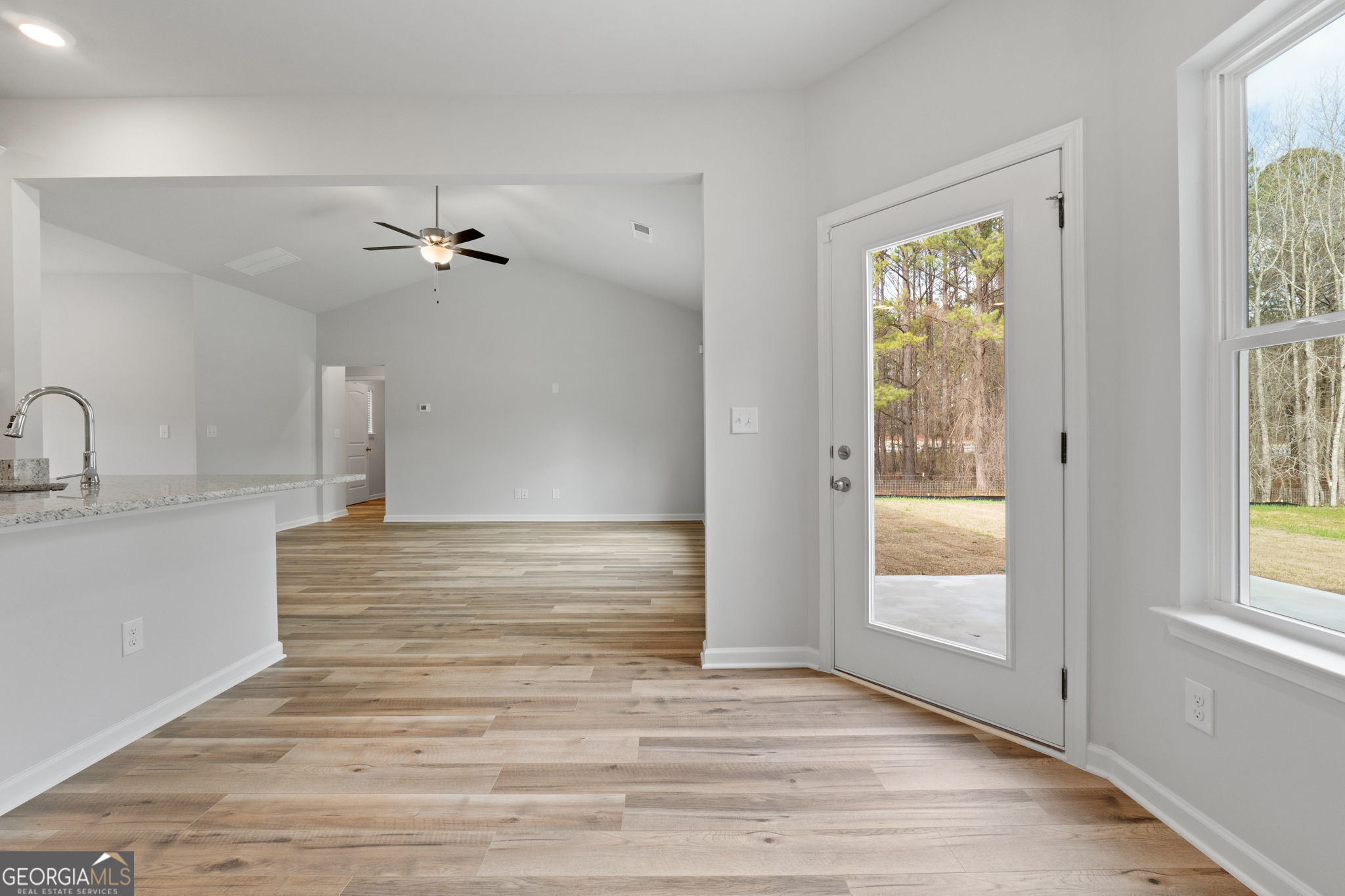 156 Charlie Fuller Road Grantville, GA 30220 - Photo 16 of 36 a view of a room with a ceiling fan window and wooden floor