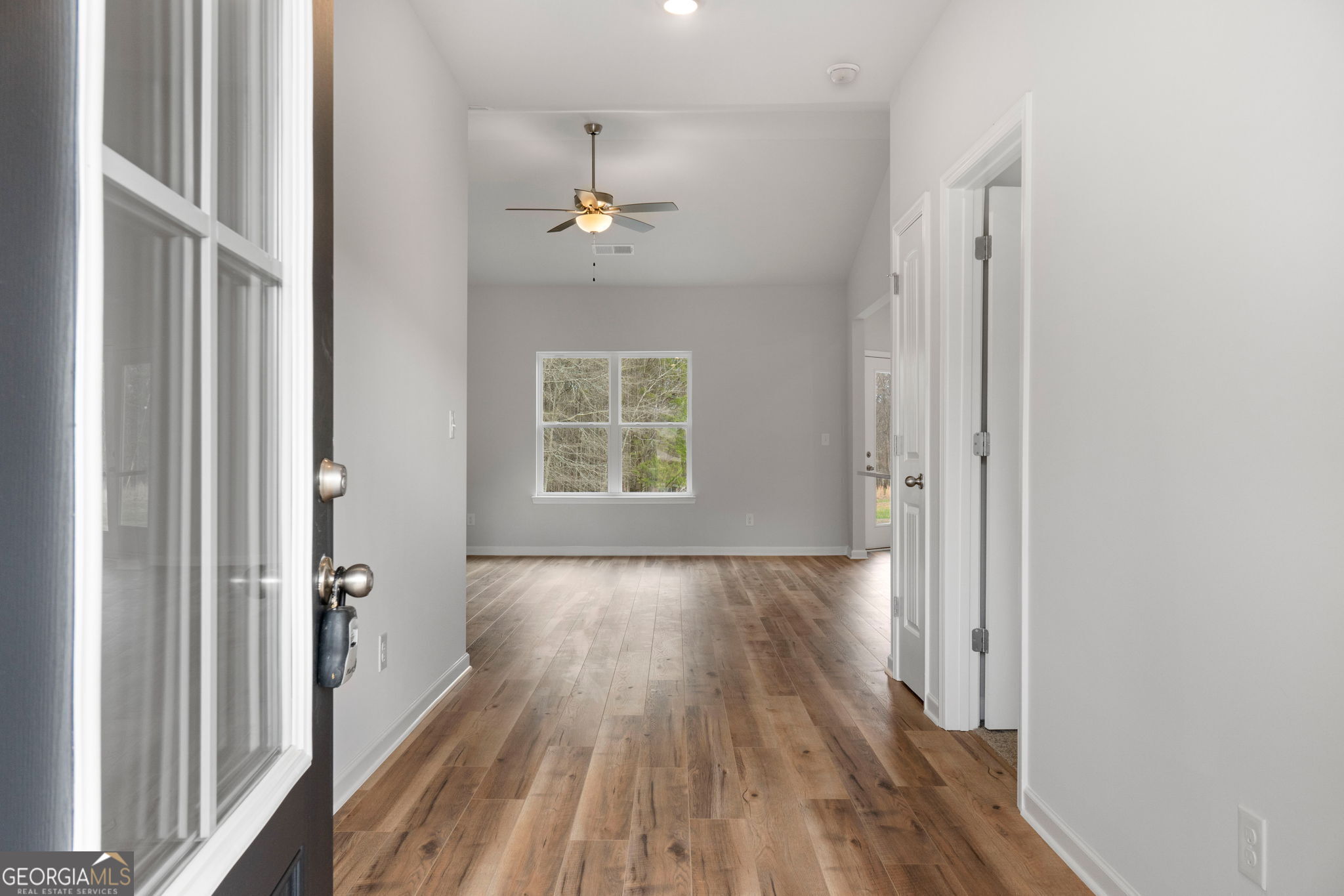 156 Charlie Fuller Road Grantville, GA 30220 - Photo 5 of 36 wooden floor in an empty room with a window