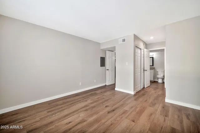a view of an empty room with wooden floor