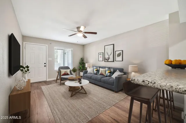 a living room with furniture and wooden floor