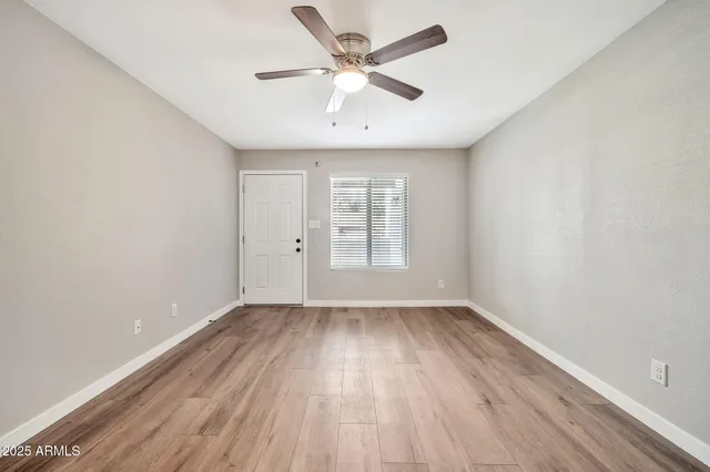 wooden floor in an empty room with a window