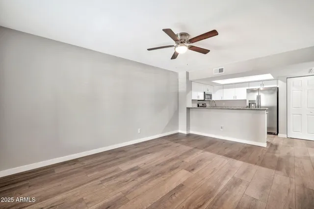 a view of a kitchen with a dishwasher and wooden floor