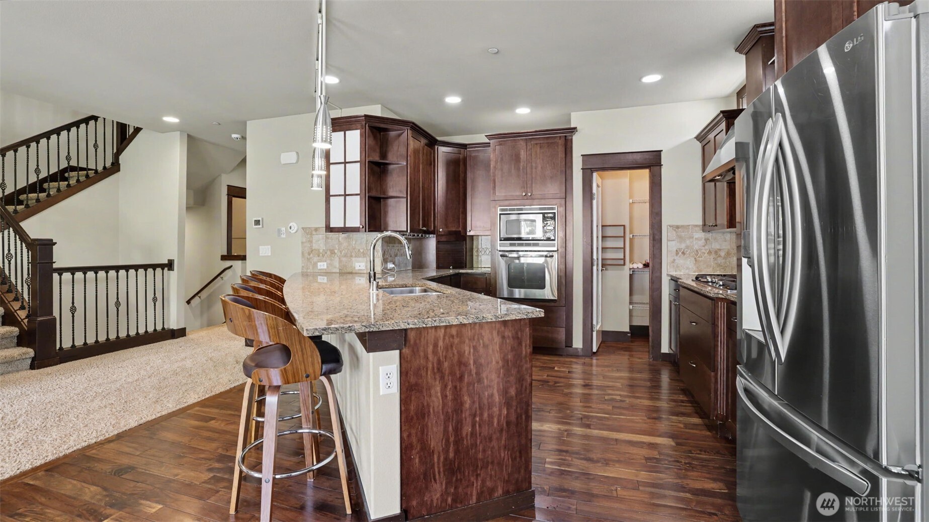 1357 Elma Place Northeast Renton, WA 98059 - Photo 9 of 40 a kitchen with stainless steel appliances refrigerator dining table and chairs