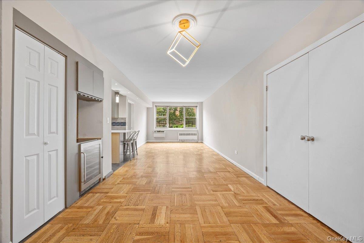 629 Kappock Street, Unit 2A Bronx, NY 10463 - Photo 13 of 36 Unfurnished living room featuring radiator heating unit and baseboards
