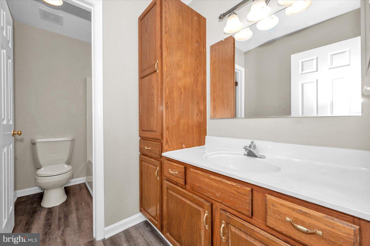 1184 Heathfield Road Sykesville, MD 21784 - Photo 25 of 56 a bathroom with a sink a toilet and a mirror