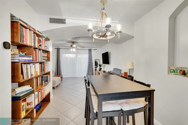 a view of a dining room with furniture and a chandelier