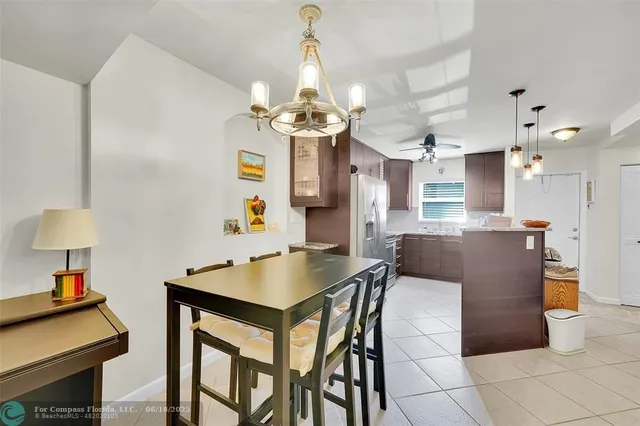 a view of a dining room with furniture and a chandelier
