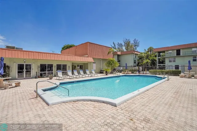 a room with pool table and window