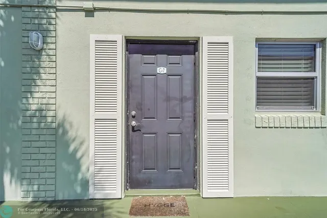 a view of a bathroom that has a sink shower and a mirror