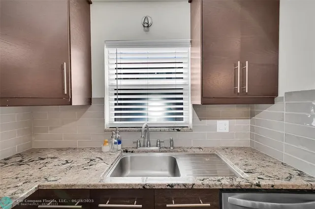 a kitchen with a sink and a window