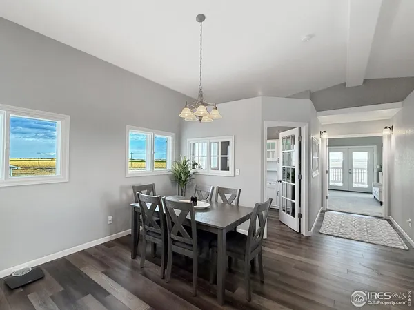 a view of a a dining room with furniture window and wooden floor