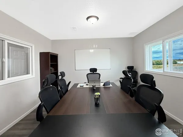 a view of a workspace with furniture and a window