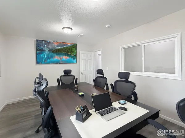 a work room with furniture and a flat screen tv